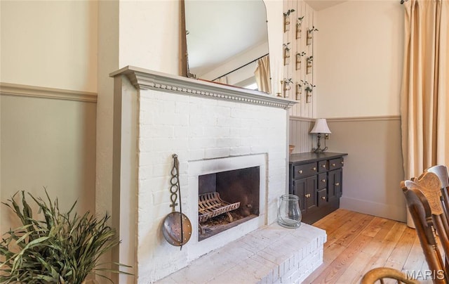 725 W Springfield St, St James, MO 65559 - living room with light wood finished floors and a brick fireplace