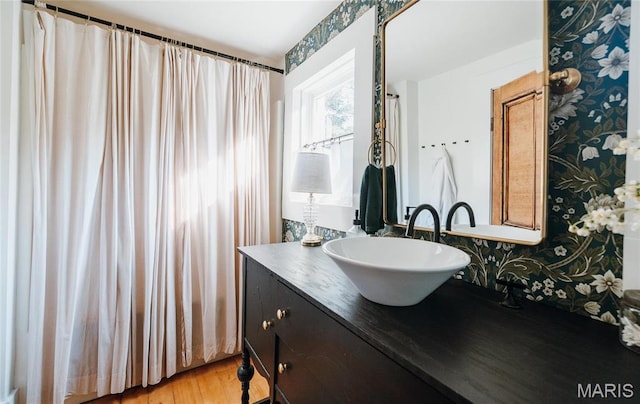 725 W Springfield St, St James, MO 65559 - bathroom featuring wallpapered walls, vanity, and wood finished floors