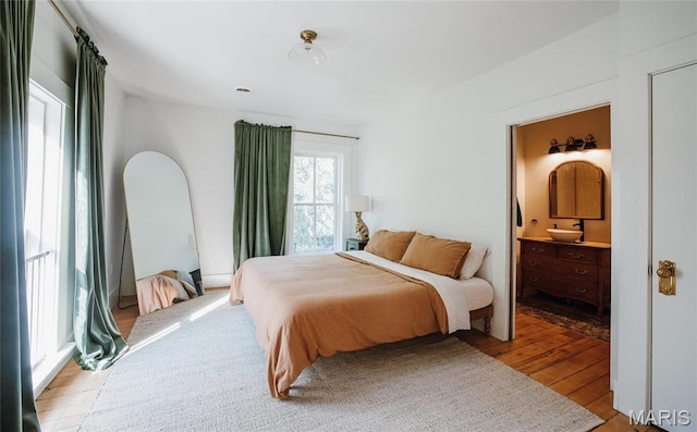 725 W Springfield St, St James, MO 65559 - bedroom featuring hardwood / wood-style floors and connected bathroom