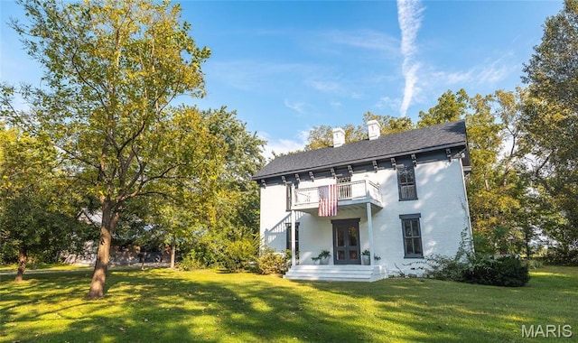 725 W Springfield St, St James, MO 65559 - back of property with a balcony, french doors, a lawn, and a chimney