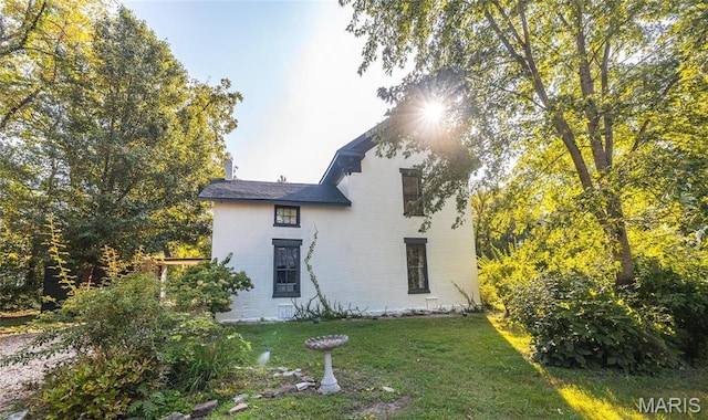 725 W Springfield St, St James, MO 65559 - rear view of house with a yard and brick siding