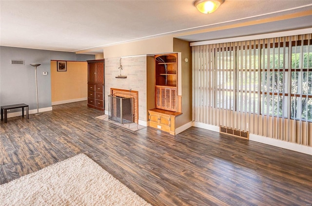 1 Debby Ln, Belleville, IL 62223 - unfurnished living room featuring baseboards, wood finished floors, and a tile fireplace