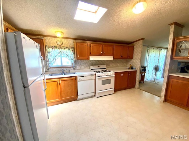 610 N Caldwell St, Middletown, MO 63359 - kitchen with white appliances, under cabinet range hood, a sink, light countertops, and a textured ceiling