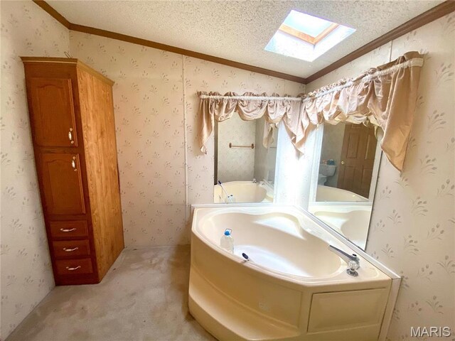 610 N Caldwell St, Middletown, MO 63359 - bathroom featuring a skylight, a bath, ornamental molding, a textured ceiling, and lofted ceiling