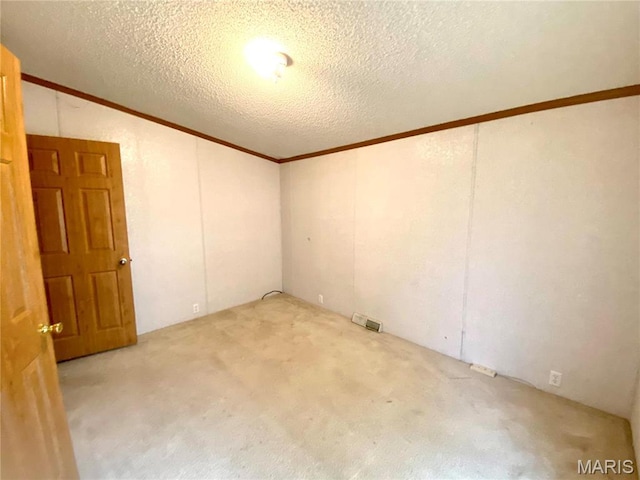 610 N Caldwell St, Middletown, MO 63359 - carpeted spare room with crown molding, vaulted ceiling, and a textured ceiling