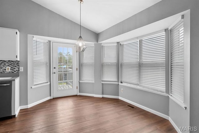 111 Aspencade Cir, Saint Peters, MO 63376 - unfurnished dining area with vaulted ceiling, wood finished floors, and baseboards