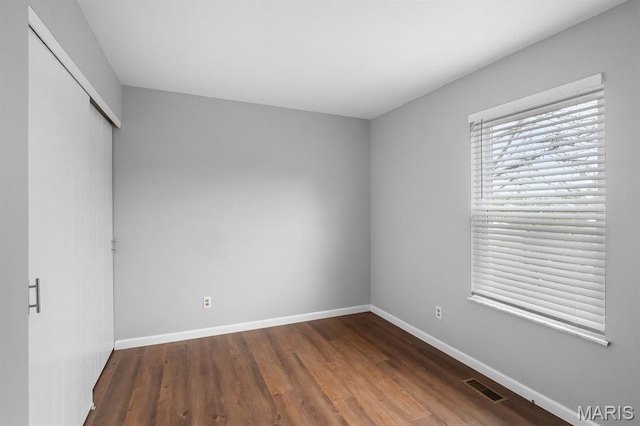 111 Aspencade Cir, Saint Peters, MO 63376 - unfurnished bedroom with wood finished floors, a closet, and baseboards