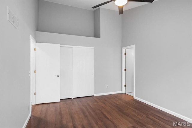 111 Aspencade Cir, Saint Peters, MO 63376 - unfurnished bedroom featuring wood finished floors, a towering ceiling, baseboards, a closet, and ceiling fan