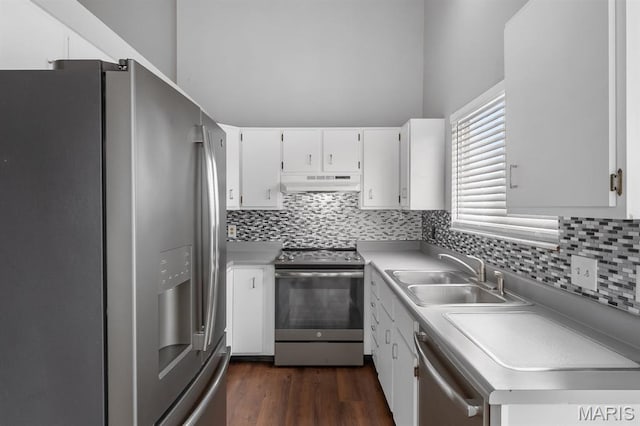 111 Aspencade Cir, Saint Peters, MO 63376 - kitchen with stainless steel appliances, a sink, under cabinet range hood, decorative backsplash, and white cabinetry