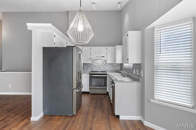 111 Aspencade Cir, Saint Peters, MO 63376 - kitchen featuring stainless steel appliances, under cabinet range hood, white cabinetry, light countertops, and dark wood-style floors