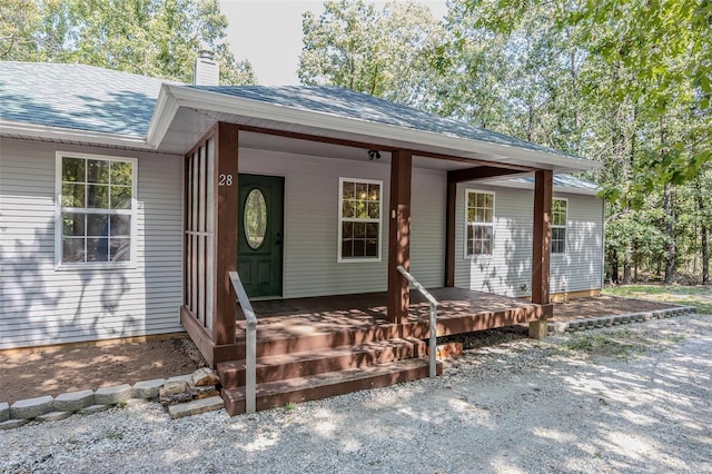 28 Acacia Dr, Conway, MO 65632 - entrance to property featuring a chimney, a shingled roof, and a porch