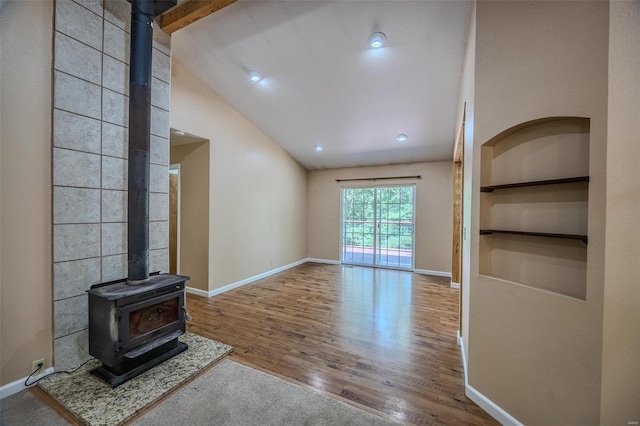 28 Acacia Dr, Conway, MO 65632 - unfurnished living room featuring a wood stove, vaulted ceiling, wood finished floors, baseboards, and recessed lighting