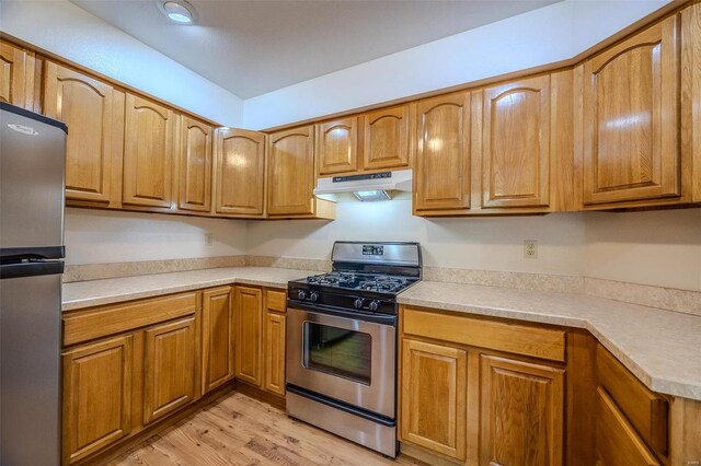 28 Acacia Dr, Conway, MO 65632 - kitchen with stainless steel appliances, under cabinet range hood, light wood-style flooring, light countertops, and brown cabinetry