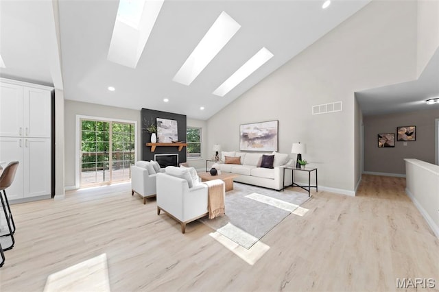 6 Freedom Way, Saint Charles, MO 63303 - living area with a skylight, light wood-type flooring, high vaulted ceiling, recessed lighting, and baseboards