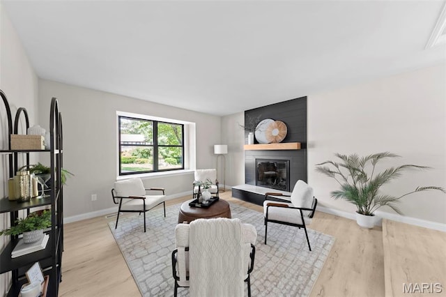 6 Freedom Way, Saint Charles, MO 63303 - living area featuring baseboards, light wood-type flooring, and a fireplace