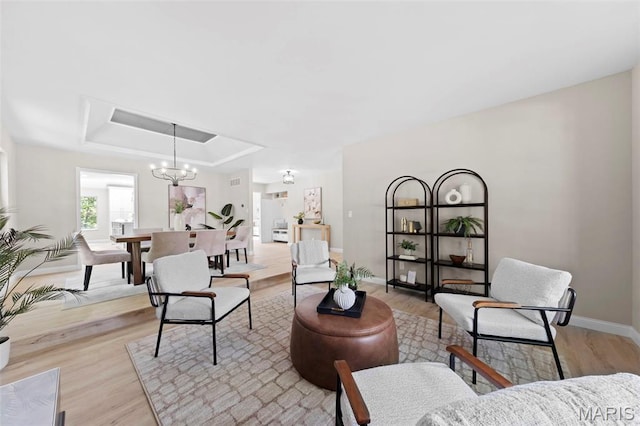 6 Freedom Way, Saint Charles, MO 63303 - living room with light wood finished floors, a chandelier, baseboards, and a raised ceiling