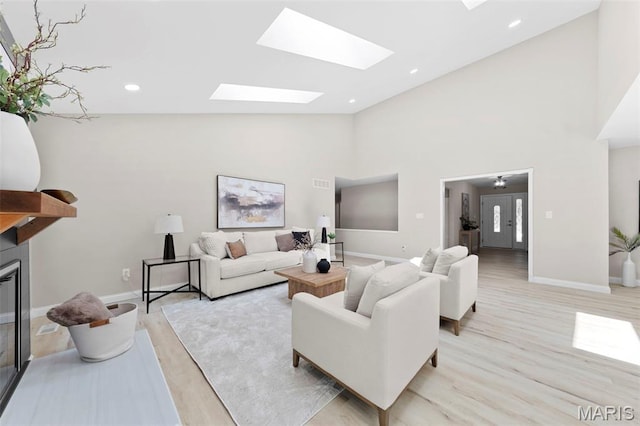 6 Freedom Way, Saint Charles, MO 63303 - living area featuring light wood-type flooring, a skylight, baseboards, high vaulted ceiling, and recessed lighting
