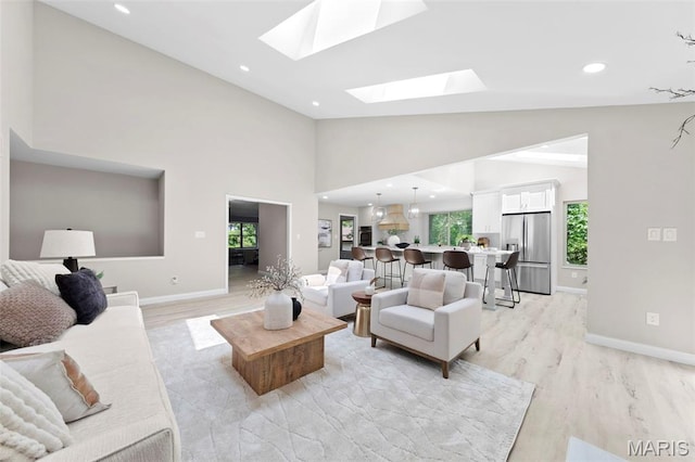 6 Freedom Way, Saint Charles, MO 63303 - living room with light wood-type flooring, plenty of natural light, a skylight, baseboards, and recessed lighting