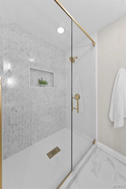 6 Freedom Way, Saint Charles, MO 63303 - full bathroom featuring a tile shower, baseboards, and marble finish flooring