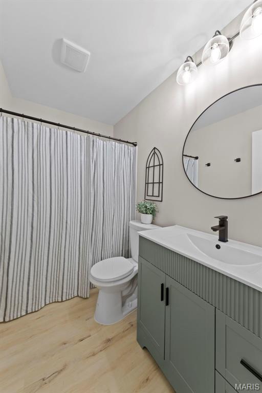 6 Freedom Way, Saint Charles, MO 63303 - full bathroom featuring wood finished floors, vanity, and toilet