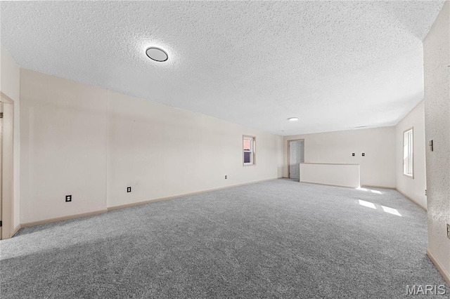 2901 Magnolia Ave, Saint Louis, MO 63118 - unfurnished room featuring a textured ceiling, carpet flooring, and baseboards