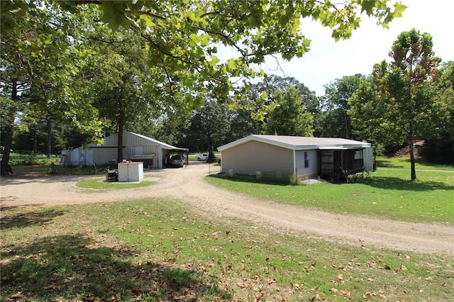 12433 State Route 101, Caulfield, MO 65626 - view of dirt / gravel driveway featuring a pole building and view of scattered trees