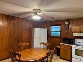 1742 Date Dr, Summersville, MO 65571 - dining area featuring wooden walls, a ceiling fan, and light flooring