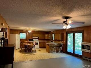 1742 Date Dr, Summersville, MO 65571 - dining area with heating unit, plenty of natural light, wood walls, and finished concrete floors