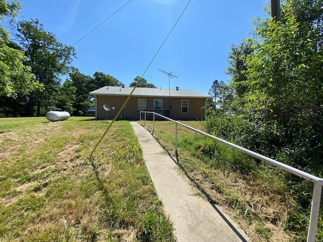 37 County Road 343, Benton Township, MO 65626 - rear view of house with a lawn and metal roof