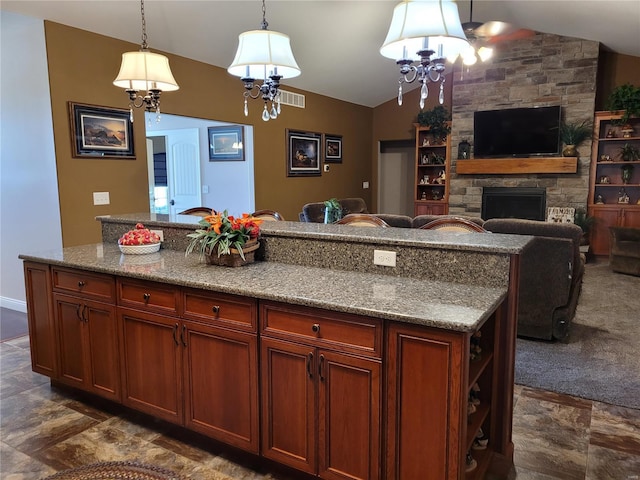 10359 Bounds Rd, Shipman, IL 62685 - kitchen with vaulted ceiling, a chandelier, a stone fireplace, stone finish floors, and hanging light fixtures