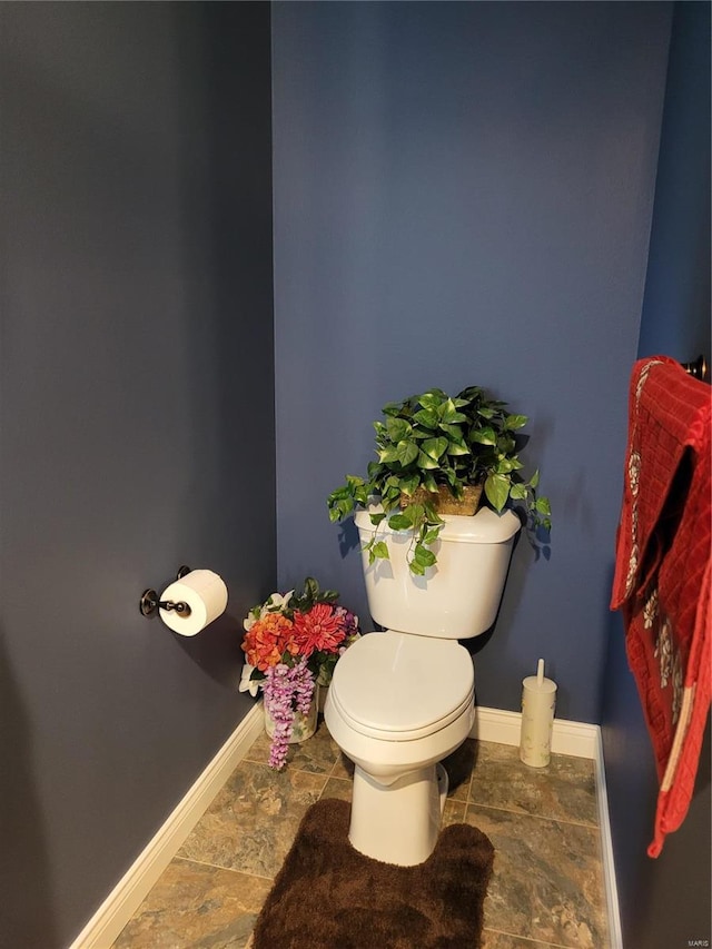 10359 Bounds Rd, Shipman, IL 62685 - bathroom with baseboards, stone finish flooring, and toilet