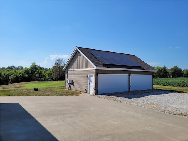10359 Bounds Rd, Shipman, IL 62685 - view of side of home featuring roof mounted solar panels, roof with shingles, a yard, and a detached garage