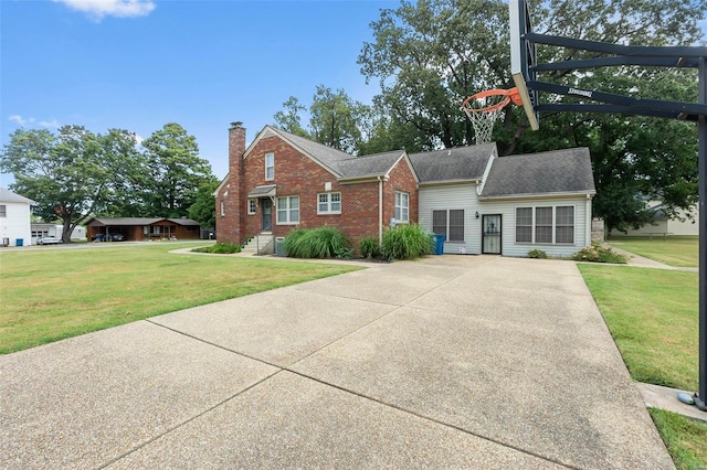 612 W Sturdivant St, Advance, MO 63730 - view of front facade featuring a chimney, a front yard, brick siding, driveway, and a shingled roof
