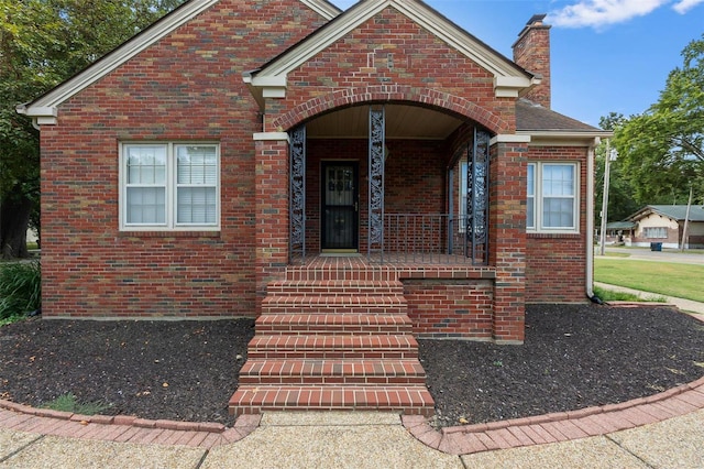 612 W Sturdivant St, Advance, MO 63730 - property entrance featuring brick siding, a chimney, and a porch