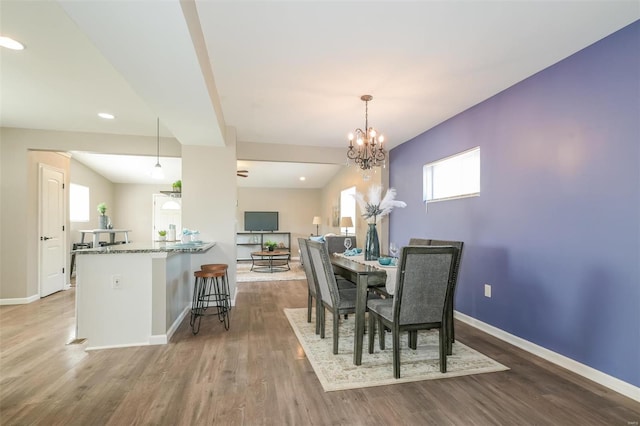 4728 Primm St, Saint Louis, MO 63116 - dining space with baseboards, wood finished floors, a chandelier, and recessed lighting