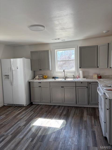 1439 N Spanish St, Cape Girardeau, MO 63701 - kitchen featuring white appliances, gray cabinets, and a sink