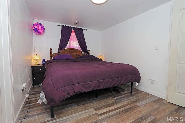 1439 N Spanish St, Cape Girardeau, MO 63701 - bedroom featuring wood finished floors and baseboards