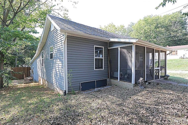 1439 N Spanish St, Cape Girardeau, MO 63701 - view of side of property featuring a sunroom, fence, and roof with shingles