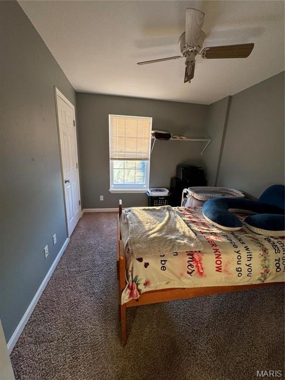 carpeted bedroom with baseboards and a ceiling fan