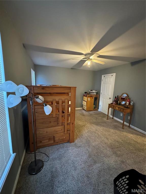 carpeted bedroom featuring baseboards and ceiling fan