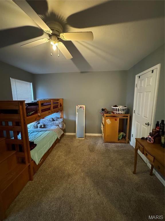 carpeted bedroom with a ceiling fan and baseboards