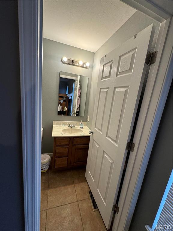 bathroom with tile patterned flooring and vanity