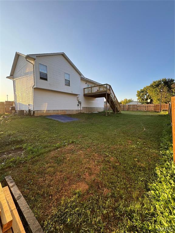 back of house featuring stairway and a deck
