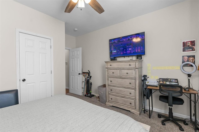 carpeted bedroom featuring baseboards and a ceiling fan