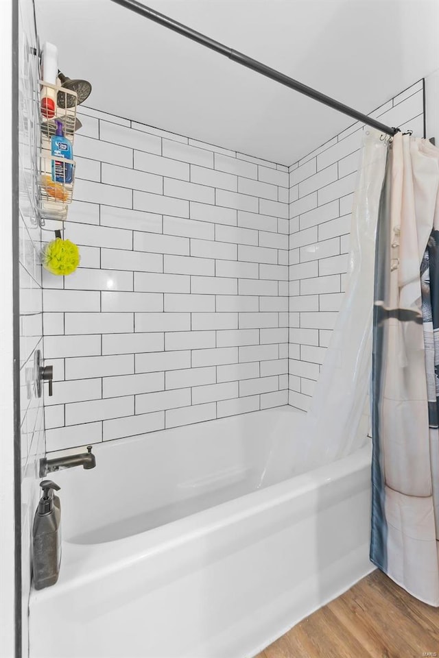 full bath with shower / bath combo and wood finished floors