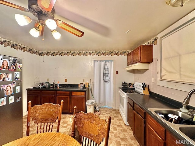 220 Louise St, Bonne Terre, MO 63628 - kitchen with white electric range, freestanding refrigerator, a sink, under cabinet range hood, and a ceiling fan