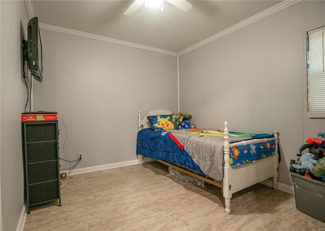 bedroom with wood finished floors, crown molding, baseboards, and a ceiling fan