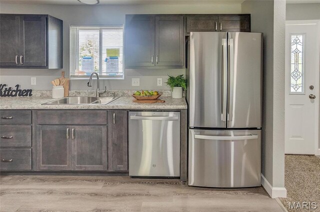 8546 US Highway 50, Lebanon, IL 62254 - kitchen featuring appliances with stainless steel finishes, light countertops, dark brown cabinets, and light wood finished floors