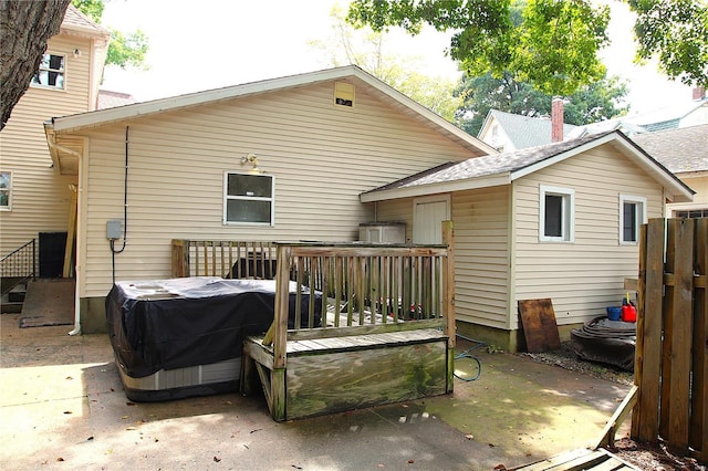 rear view of house featuring a wooden deck