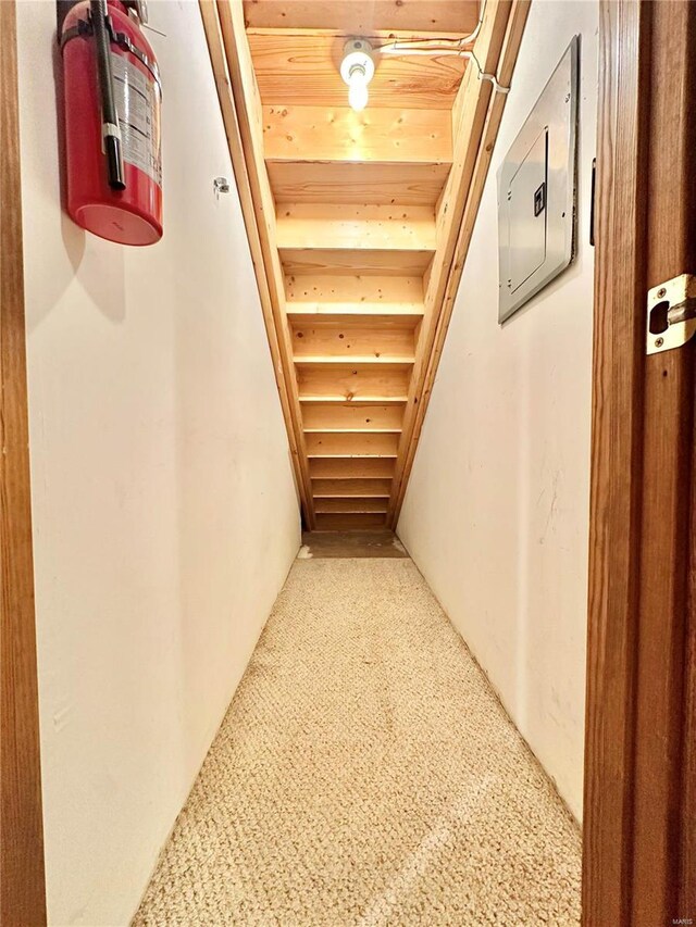 corridor featuring electric panel and wooden ceiling